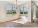 Bright dining area with two windows providing scenic views and natural light at 10818 Breaking Rocks Dr, Tampa, FL 33647