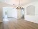 Open concept dining room featuring hardwood floors and an elegant chandelier at 10818 Breaking Rocks Dr, Tampa, FL 33647