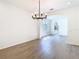 Dining area with hardwood floors, decorative chandelier, and connecting archways at 10818 Breaking Rocks Dr, Tampa, FL 33647