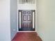 Front door entrance to this home featuring sidelights and a brick paver floor at 10818 Breaking Rocks Dr, Tampa, FL 33647