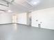 Spacious garage featuring ample lighting and neutral paint at 10818 Breaking Rocks Dr, Tampa, FL 33647