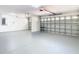 Clean two car garage with ample parking, lighting, and storage at 10818 Breaking Rocks Dr, Tampa, FL 33647