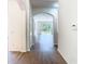 Bright hallway with wood floors and arched doorway leading to the living room at 10818 Breaking Rocks Dr, Tampa, FL 33647