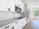 New white kitchen with granite countertops, stainless steel appliances, and subway tile backsplash at 10818 Breaking Rocks Dr, Tampa, FL 33647