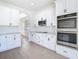 New kitchen with granite countertops, stainless appliances, subway tile, and an arched doorway at 10818 Breaking Rocks Dr, Tampa, FL 33647
