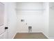 Empty laundry room with hook ups, shelving, and neutral paint at 10818 Breaking Rocks Dr, Tampa, FL 33647