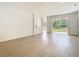 Bright living room with wood-look flooring and sliding glass doors to the backyard at 10818 Breaking Rocks Dr, Tampa, FL 33647