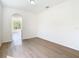 Bright living room with hardwood floors and a view through the arched doorway to another room at 10818 Breaking Rocks Dr, Tampa, FL 33647