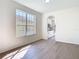 Bright living room with hardwood floors and a view through the arched doorway to the kitchen at 10818 Breaking Rocks Dr, Tampa, FL 33647
