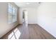 Bright living room with hardwood floors and a window providing natural light at 10818 Breaking Rocks Dr, Tampa, FL 33647