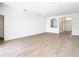 Spacious living room featuring wood-look flooring and an open archway at 10818 Breaking Rocks Dr, Tampa, FL 33647