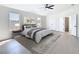 Spacious main bedroom with ceiling fan, carpet, and ensuite bathroom access at 10818 Breaking Rocks Dr, Tampa, FL 33647
