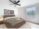 Beautifully staged main bedroom with view, featuring contemporary decor and a calming color palette at 10818 Breaking Rocks Dr, Tampa, FL 33647