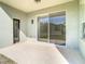 Covered patio overlooking backyard with sliding glass doors and tile flooring at 10818 Breaking Rocks Dr, Tampa, FL 33647