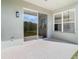 Covered patio with tile flooring, sliding glass doors, and a view of the green lawn at 10818 Breaking Rocks Dr, Tampa, FL 33647