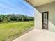 Covered patio showcasing backyard with lush greenery and water view at 10818 Breaking Rocks Dr, Tampa, FL 33647