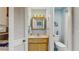 Compact bathroom with tile floors, wood vanity, and mirrored medicine cabinet at 11135 Carriage Hill Dr # 5, Port Richey, FL 34668