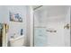 Bright bathroom featuring a white tile shower with a glass door and a stylish turtle themed art piece at 11135 Carriage Hill Dr # 5, Port Richey, FL 34668