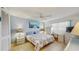 Comfortable bedroom with a ceiling fan, tropical themed bedding, and a bright workspace at 11135 Carriage Hill Dr # 5, Port Richey, FL 34668