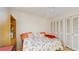 Comfortable bedroom with closet, tropical themed bedding, and decorative shelving with beach decor at 11135 Carriage Hill Dr # 5, Port Richey, FL 34668