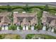 Aerial view of a community with well-maintained lawns, mature trees, and convenient street parking at 1120 Radison Ave # 6, Sun City Center, FL 33573