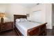 Cozy bedroom featuring hardwood floors, a queen bed, and an ample closet with white sliding doors at 1120 Radison Ave # 6, Sun City Center, FL 33573