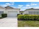 Charming single-story villa showcasing a well-maintained exterior, driveway, and manicured landscaping at 1120 Radison Ave # 6, Sun City Center, FL 33573