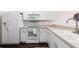 Well-lit kitchen with white appliances and ample counter space at 1120 Radison Ave # 6, Sun City Center, FL 33573