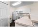 Bright kitchen with white cabinets, sink, and appliances at 1120 Radison Ave # 6, Sun City Center, FL 33573