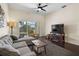 Inviting living room featuring a comfortable sectional sofa, dark hardwood floors, and a ceiling fan at 1120 Radison Ave # 6, Sun City Center, FL 33573