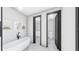 A sleek, modern bathroom with a standalone tub and black hardware accents at 1215 E Broad St, Tampa, FL 33604