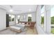 This bright bedroom boasts neutral tones, plush bedding, and a modern chair at 1215 E Broad St, Tampa, FL 33604