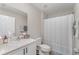 Bright bathroom featuring a modern vanity, toilet, and shower with a stylish curtain at 12970 Pasture Woods Pl, Lithia, FL 33547