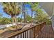 Second story deck overlooking fenced backyard with lush lawn and mature trees at 1320 Coral S Way, St Petersburg, FL 33705