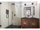 Modern bathroom featuring dual sinks, vanity with geometric design, and a sleek glass-enclosed shower at 1320 Coral S Way, St Petersburg, FL 33705