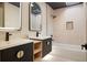 Modern bathroom with dual sinks, a soaking tub, and stylish black and gold hardware at 1320 Coral S Way, St Petersburg, FL 33705