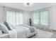 Bright bedroom with soft natural light, sheer curtains, plush rug and a modern light fixture at 1320 Coral S Way, St Petersburg, FL 33705