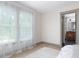 Bright bedroom showcasing light wood floors, and view into a stylish bathroom with unique vanity at 1320 Coral S Way, St Petersburg, FL 33705