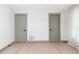 Bright bedroom with light wood floors, two closet doors and neutral walls and trim at 1320 Coral S Way, St Petersburg, FL 33705