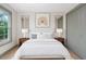 Stylishly staged bedroom featuring art over bed, bedside lamps, mirrors and gray trim at 1320 Coral S Way, St Petersburg, FL 33705