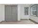 Bright bedroom featuring light wood floors, dual windows, and a closet with sliding doors at 1320 Coral S Way, St Petersburg, FL 33705