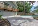 Home exterior featuring an in-ground pool, a paved driveway, mature trees, and a second-story balcony at 1320 Coral S Way, St Petersburg, FL 33705