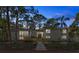 Charming home exterior with beautiful landscaping, large windows and a well-lit walkway creating a welcoming approach at 1320 Coral S Way, St Petersburg, FL 33705