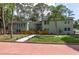 Landscaped home exterior with colorful walkway and lush lawn, and a home featuring a second story balcony at 1320 Coral S Way, St Petersburg, FL 33705