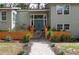 Home's elegant exterior boasts manicured landscaping, a walkway and a inviting turquoise front door at 1320 Coral S Way, St Petersburg, FL 33705