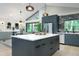 Contemporary kitchen featuring sleek cabinetry, stainless steel appliances, and an island with a quartz countertop at 1320 Coral S Way, St Petersburg, FL 33705