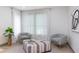 Comfortable sitting area featuring stylish chairs, a patterned ottoman, and ample natural light at 1320 Coral S Way, St Petersburg, FL 33705