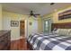 Bedroom with a wood bed frame, hardwood flooring, a ceiling fan, and natural light at 1400 Pine Glen Ln # D2, Tarpon Springs, FL 34688