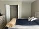 Bedroom showcasing a bed and dresser with a closet door open at 14305 Tennyson Dr, Hudson, FL 34667