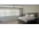 Spacious bedroom featuring a ceiling fan, large windows, and modern decor at 14305 Tennyson Dr, Hudson, FL 34667